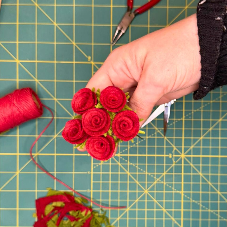 Top down image of 6 roses assembled in a bouquet.
