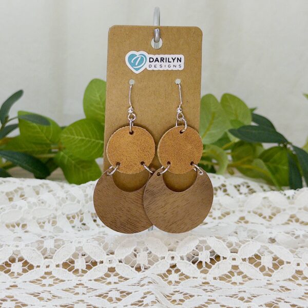 Pair of earrings featuring stacked faux suede and wood geometric shapes.