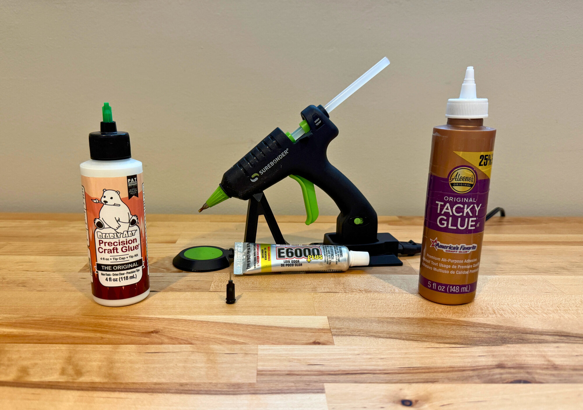 The four studio glues: Bearly Art Precision Craft Glue, a mini high-temp hot glue gun, E6000, and Aleene's Original Tacky