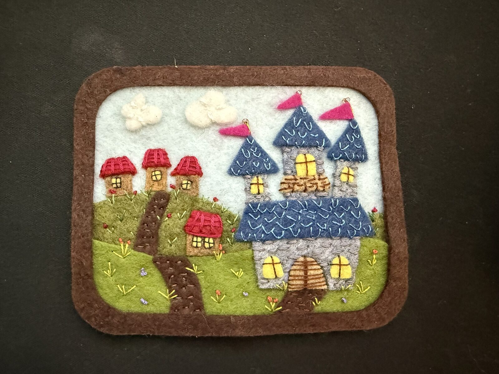 A Long Walk, finished: embroidered felt castle scene with rhinestones in its frame