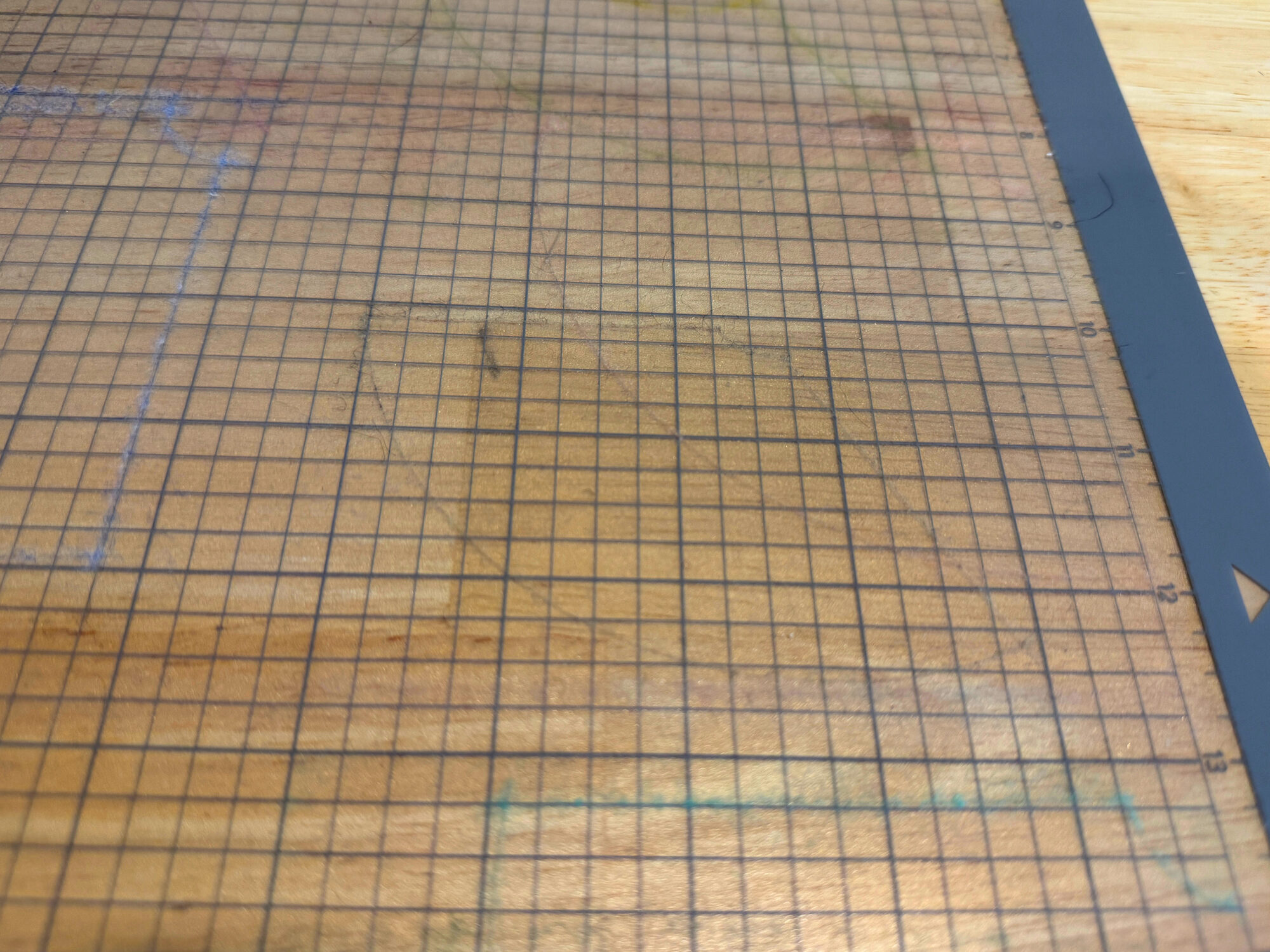 A cutting mat after a freezer-paper felt cut, with only a little lint