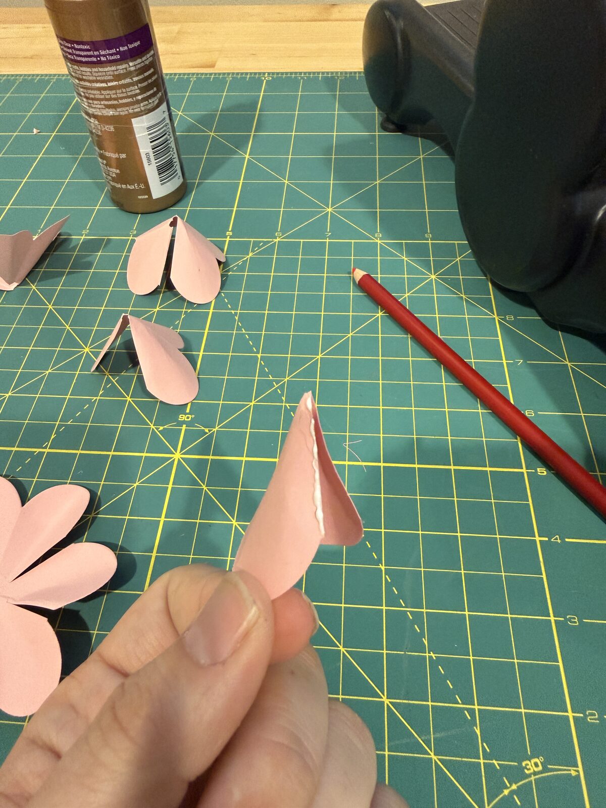 Thin line of glue on petal group edge.