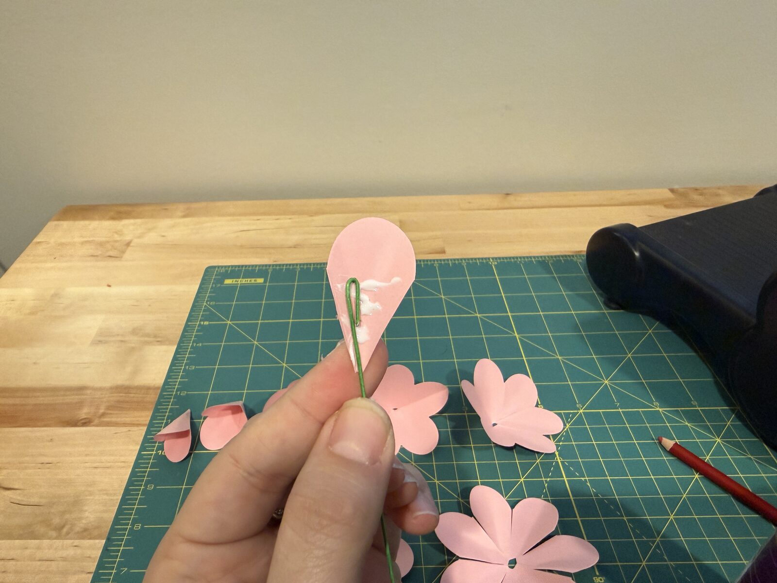 Single petal being glued to wire