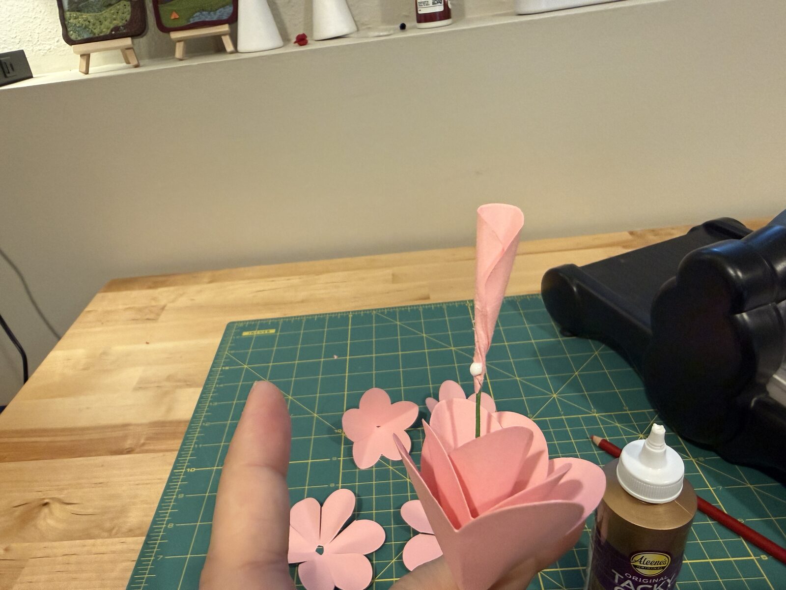 Medium sized dot of glue on end of petal group
