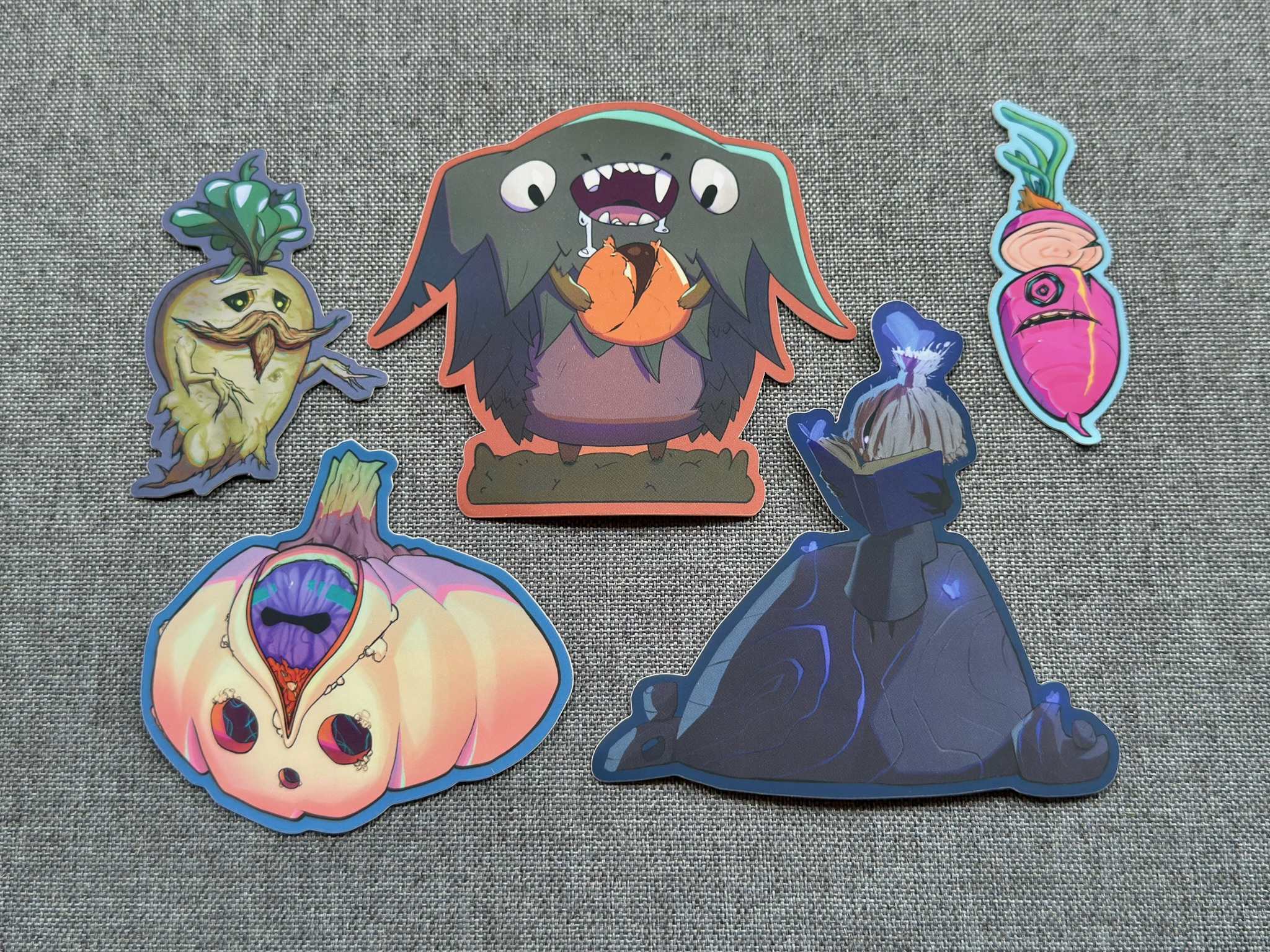 Five illustrated Halloween stickers drawn by Kor, laid out on a gray background