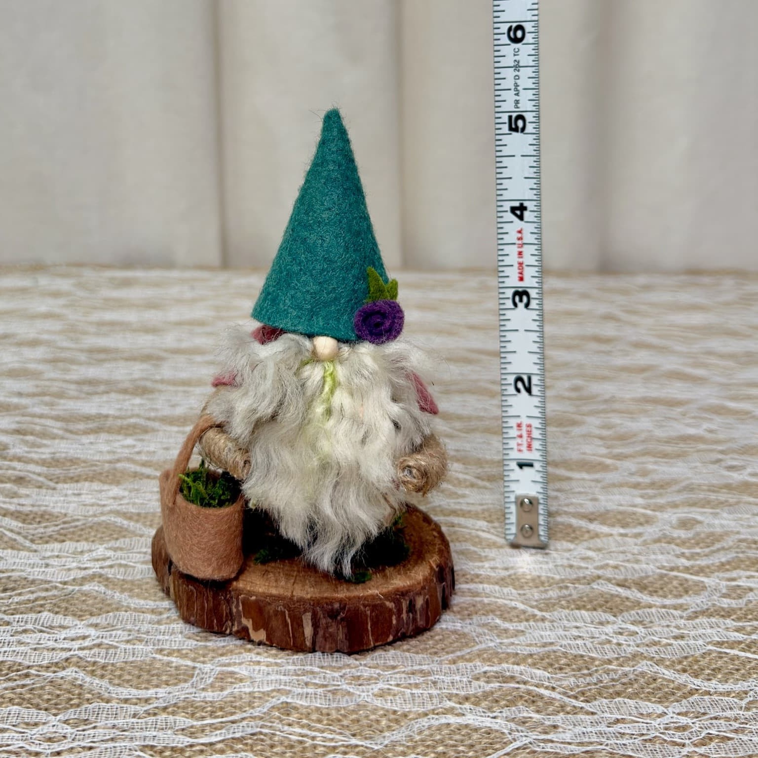 Earl the handmade gnome next to a ruler, standing about 5 inches tall