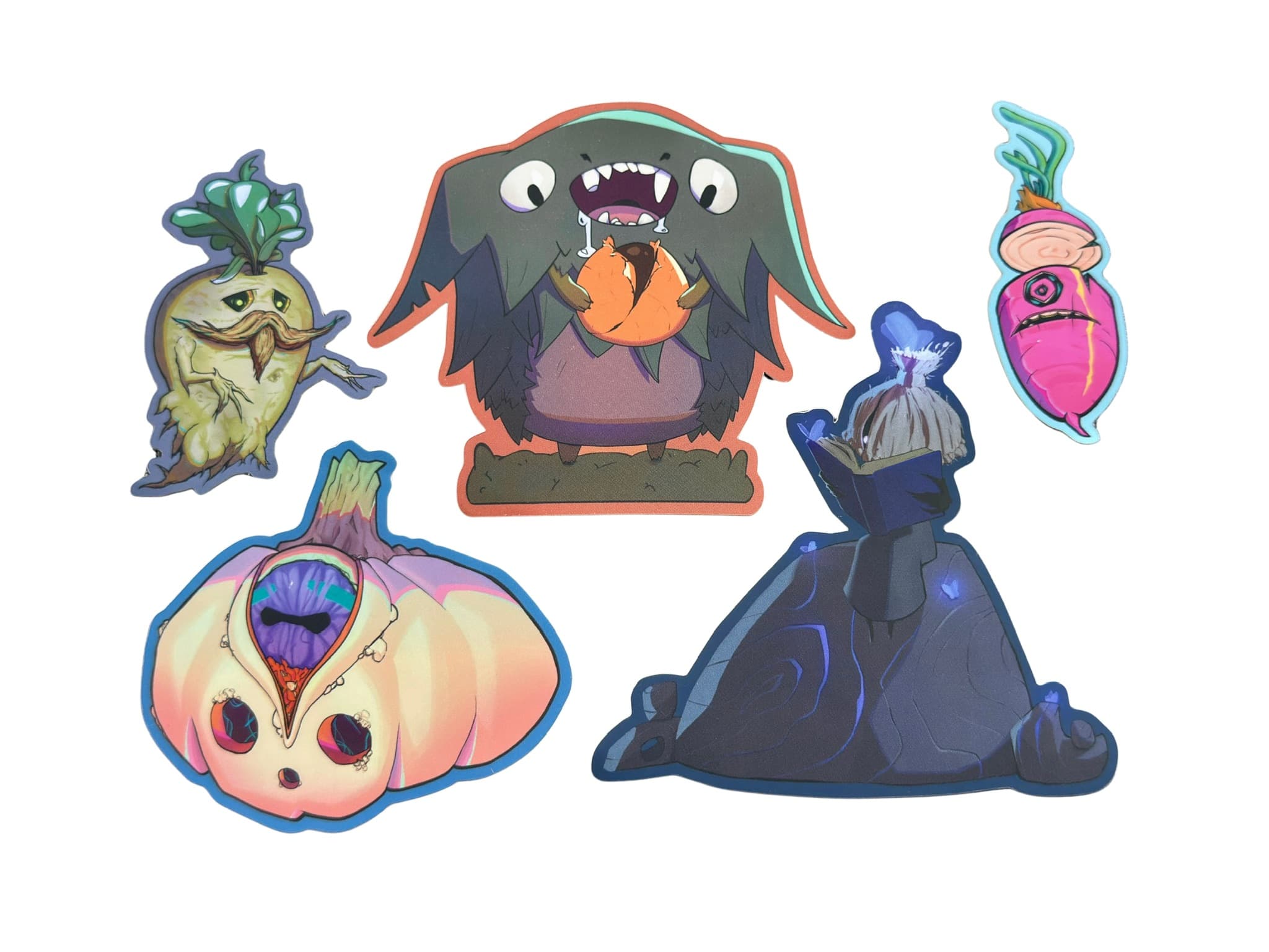 The five Mystic Garden stickers by Kor on a white background: Fredrik the Mandrake, Devon the Candy Thief, Benny the pink radish, Gus the one-eyed pumpkin, and Shien reading a book